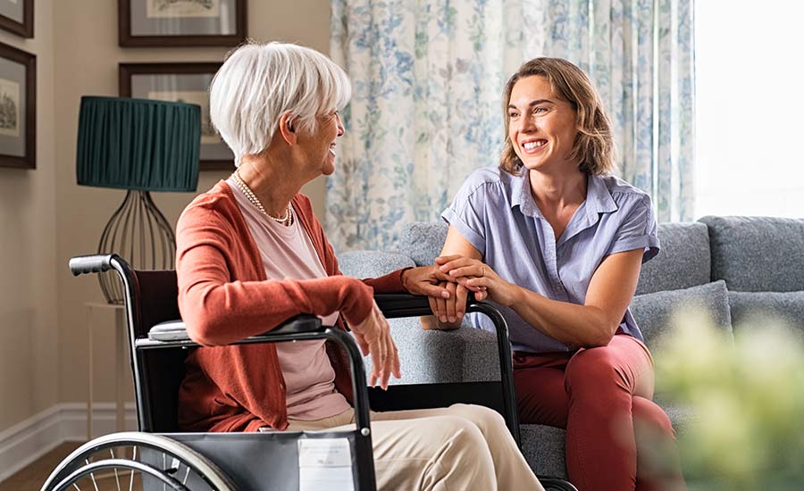 An elderly patient talking to her caregiver