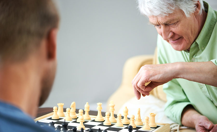 A senior male playing chess