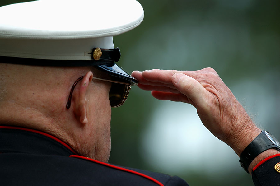 An elderly veteran honoring other veterans​