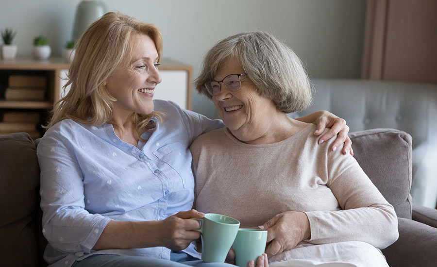 An elderly woman and her adult child bonding​