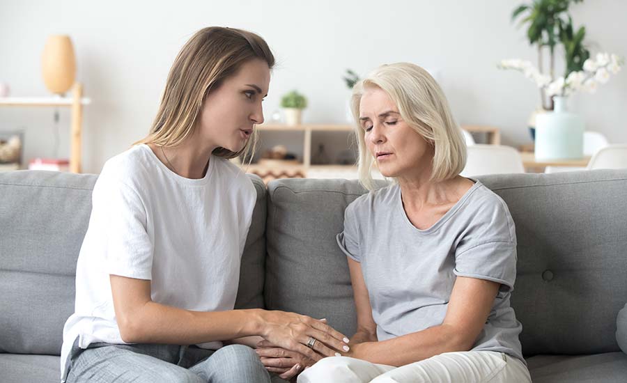 An elderly woman talking to her adult child​