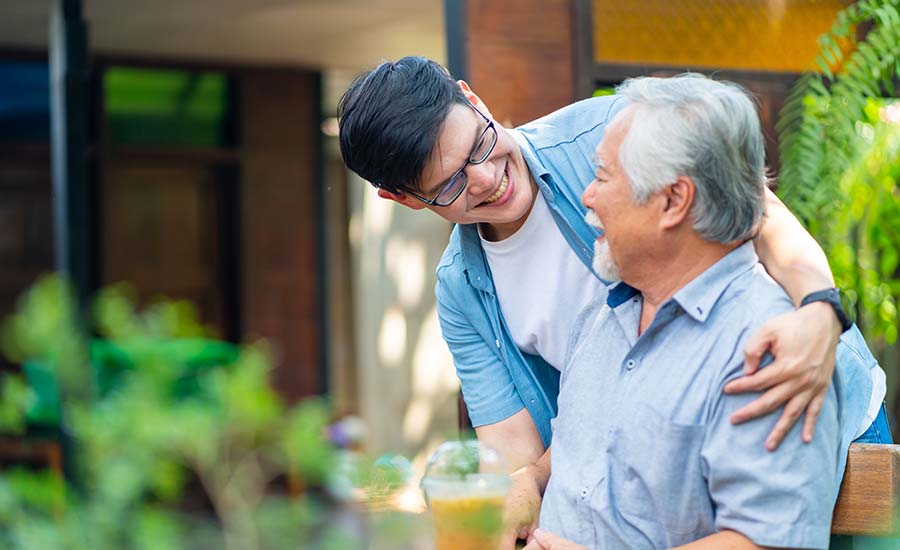 An adult child caring for his elderly parent​