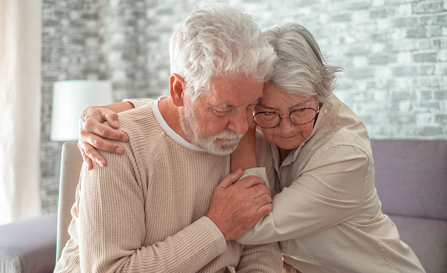 An elderly couple offering comfort to one another​