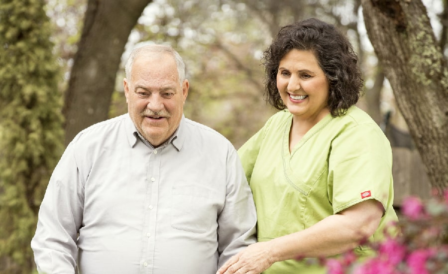 female caregiver helping a senior